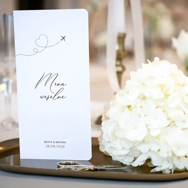 Menu weselne w formie książeczki z motywem podróżniczym, elegancki dodatek na stół.