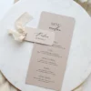 leżące menu weselne na papierze z delikatnymi drobinkami w beżowym odcieniu